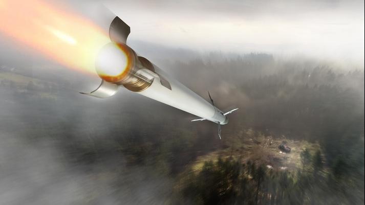 An APKWS laser-guided rocket speeds toward a designated target on the ground.