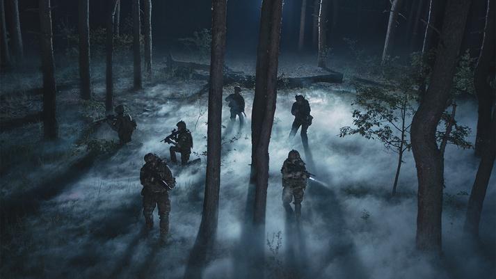 Soldiers execute a mission in low light conditions.  