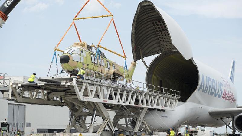 The BelugaST is ready to transport outsized cargo, like helicopters, across the world, as demonstrated here during testing earlier in 2021. / ⒸAirbus S.A.S.