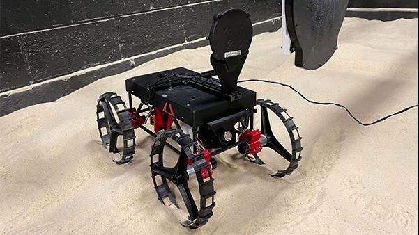  A 3D printed Astrobotic CubeRover demonstrates the wireless charging system. The Onboard Charger mounted on the CubeRover approaches the Power Transmitter.