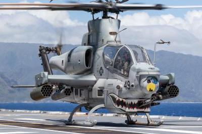 A U.S. Marine Corps UH-1Y Venom helicopter launches from the flight deck of Royal Australian Navy Canberra-class landing helicopter dock HMAS Canberra (L02) above a U.S. Marine Corps AH-1Z Viper helicopter during Rim of the Pacific (RIMPAC) 2022. Royal Australian Navy Leading Seaman Matthew Lyall Photo