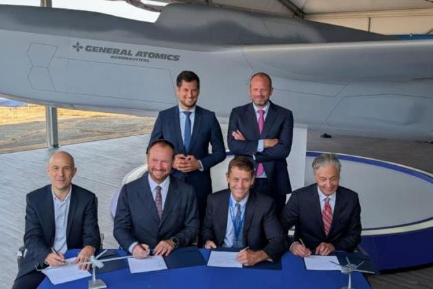 An industrial cooperation MOU was signed on July 22. Seated (left to right): dotOcean CEO Koen Geirnaert, Thales Belgium CEO Alain Quevrin, GA-ASI CEO Linden Blue, and Octave VP in Europe Maximilian Weber. Standing (left to right): Ministre-President de la Wallonie Adrien Dolimont, and Belgium Defence and Foreign Trade Minister Theo Franken.